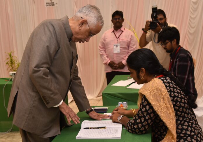 Andhra Pradesh Governor Abdul Nazeer casts his vote at a polling center in Vijayawada.