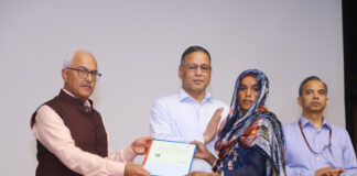 Union Home Secretary Ajay Kumar Bhalla hands over a citizenship certificate to an applicant in New Delhi on Wednesday.