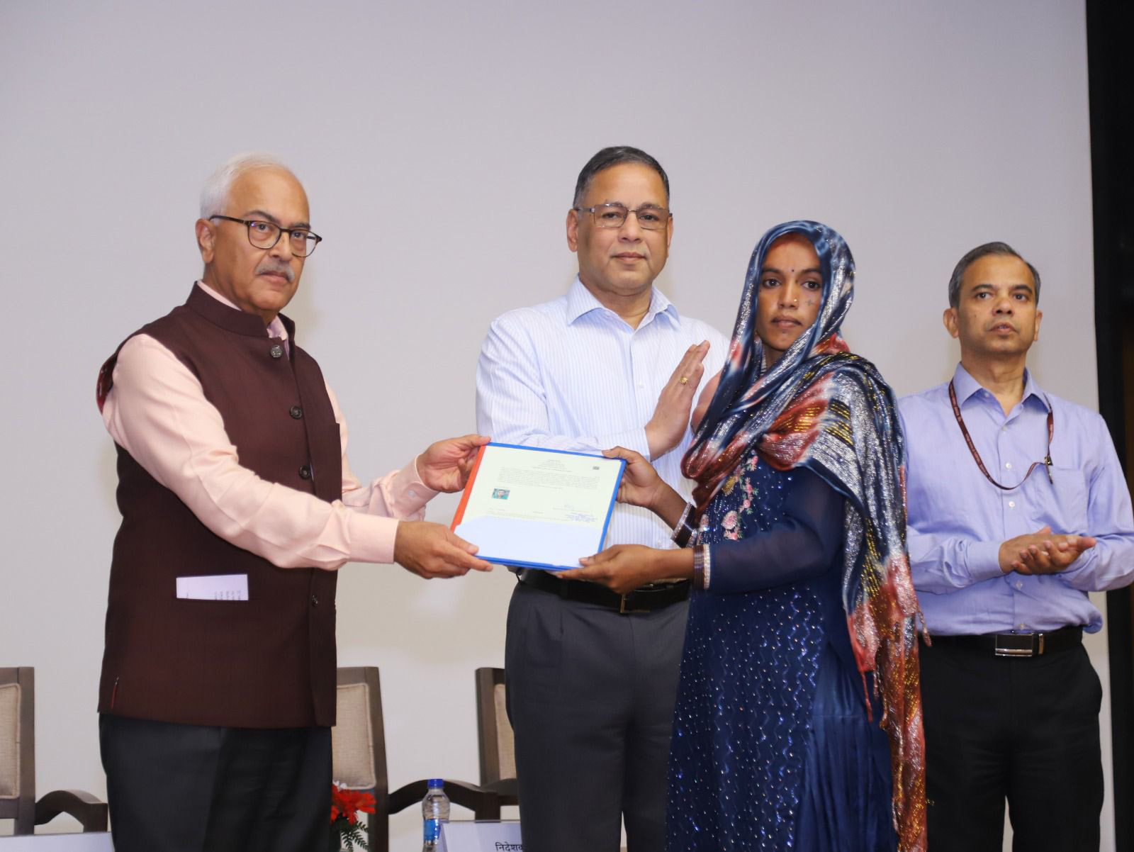 Union Home Secretary Ajay Kumar Bhalla hands over a citizenship certificate to an applicant in New Delhi on Wednesday.