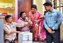 Election officials facilitate a person with disability cast his vote in Hyderabad