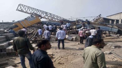 Collapsed crane at a cement bricks factory in Rangareddy district with workers and officials inspecting the accident site