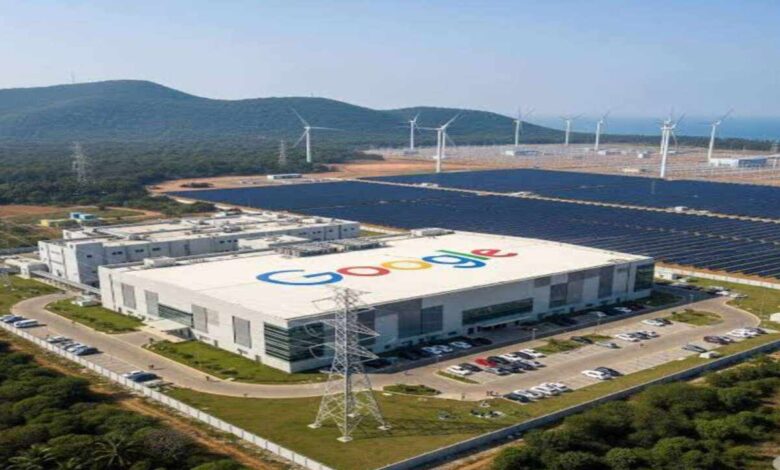 Aerial view of Google data center building with solar panels and wind turbines in a green landscape