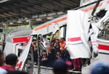 Rescue teams work at the site of a train collision near Jakarta where multiple casualties and injuries were reported