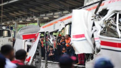 Rescue teams work at the site of a train collision near Jakarta where multiple casualties and injuries were reported