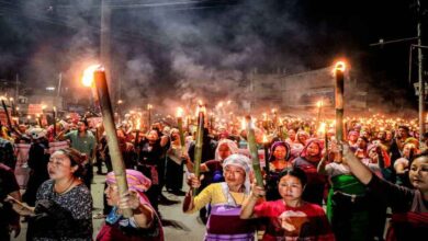 Protesters holding torches during Manipur torch rally protest in Imphal as police intervene to control crowd