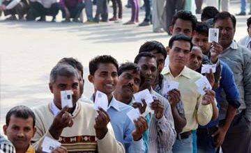 Voters standing in long queues at polling stations during Tamil Nadu and West Bengal assembly elections with high voter turnout