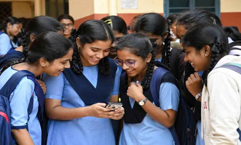 Students checking Telangana Class 10 results on mobile phone after result announcement