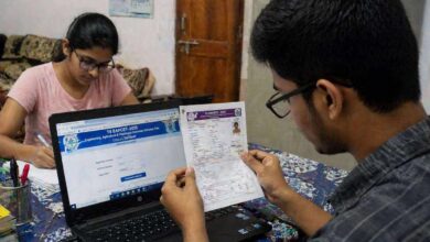 Students checking and downloading Telangana EAPCET hall ticket on laptop and printed copy at home