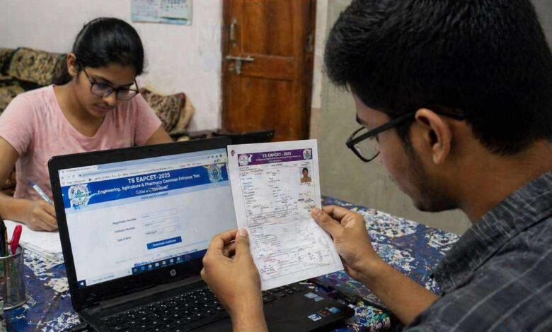 Students checking and downloading Telangana EAPCET hall ticket on laptop and printed copy at home