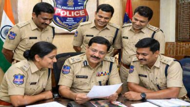Group of Telangana Police officers in uniform discussing documents during an official meeting indoors