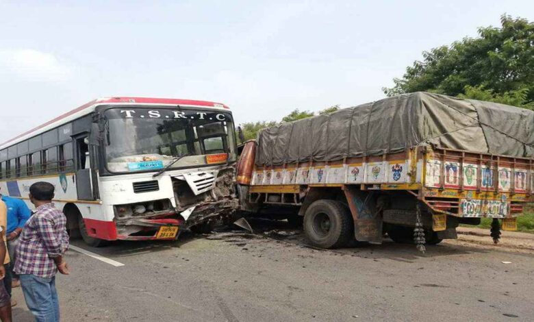 Damaged RTC bus and lorry after collision on Medak highway in Telangana with emergency response at accident site