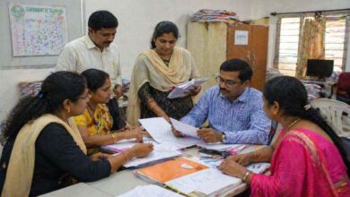 Officials and teachers review documents during discussions on Telangana teacher promotions and mandatory TET qualification rules