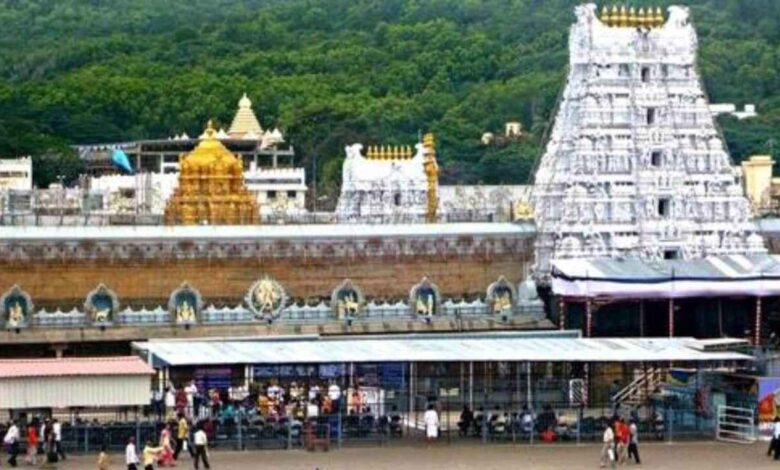 Devotees walking under shaded shelters at Tirumala temple during hot summer weather