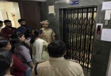 Police officers and residents standing near a hostel lift in Gachibowli during investigation into a child death accident.