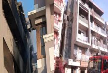 Firefighters conducting rescue operation in a residential building after a deadly fire in Vivek Vihar East Delhi