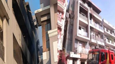 Firefighters conducting rescue operation in a residential building after a deadly fire in Vivek Vihar East Delhi