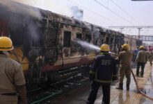 Firefighters and railway officials controlling blaze after coach of Antyodaya Express caught fire at Madhubani Railway Station