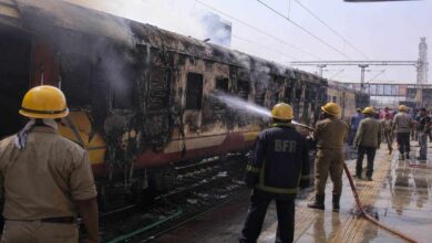 Firefighters and railway officials controlling blaze after coach of Antyodaya Express caught fire at Madhubani Railway Station