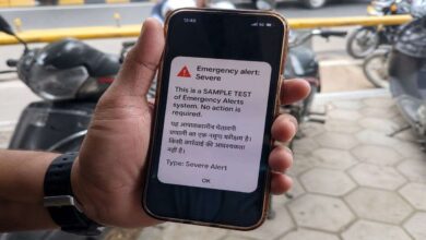 Smartphone showing emergency alert test message during nationwide mobile siren alert system trial for disaster preparedness in India
