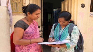 Enumerator recording family and housing details during Telangana statewide housing census and house listing survey at a residential area
