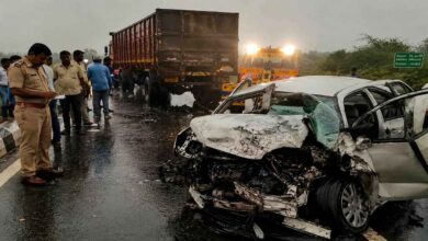 Police and rescue teams inspect a damaged car after a fatal road accident on the Trichy Coimbatore National Highway in Tamil Nadu